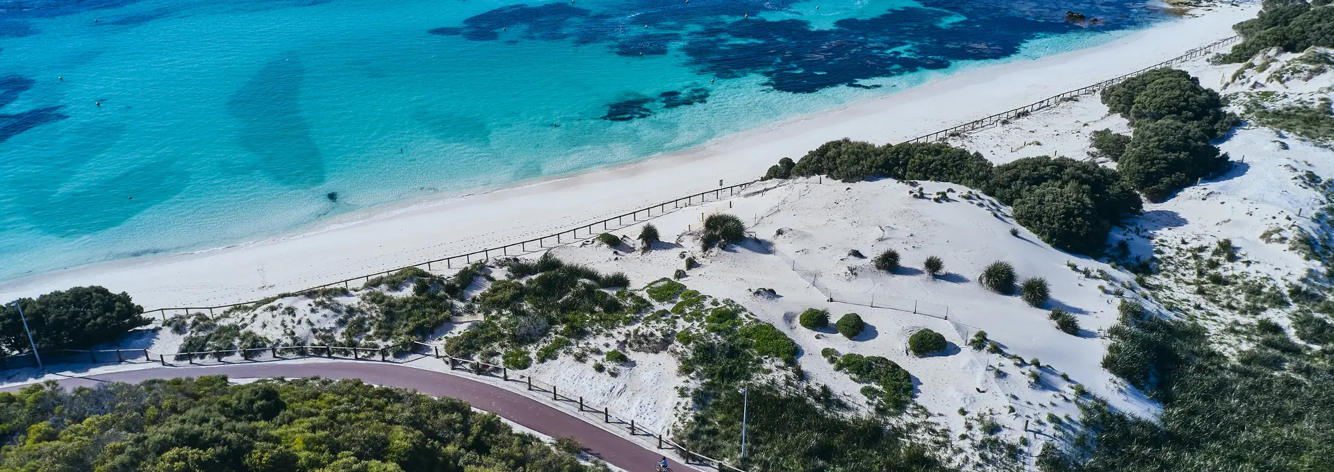 Longreach Bay accommodation above a calm Rottnest beach